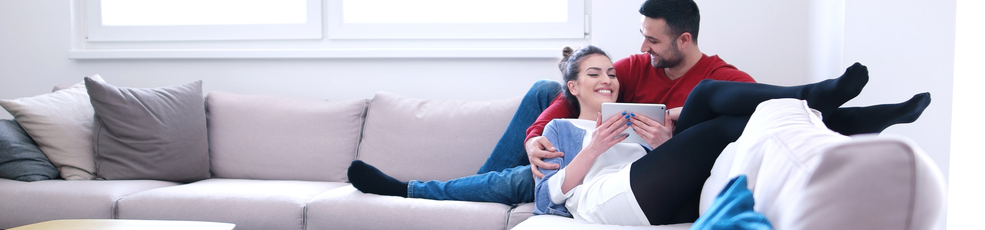 young couple smiling on the couch