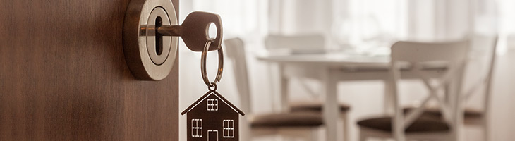A key with a keychain shaped as a house