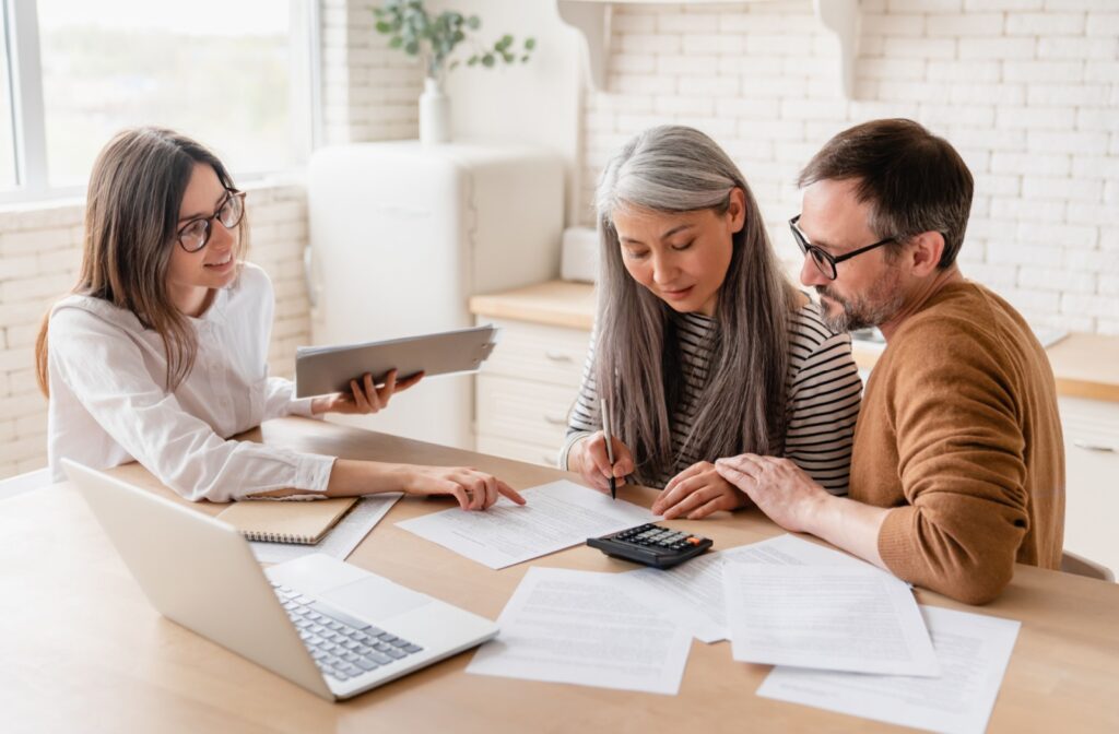 A mortgage broker helping a couple afford a down payment amount using a financial plan.