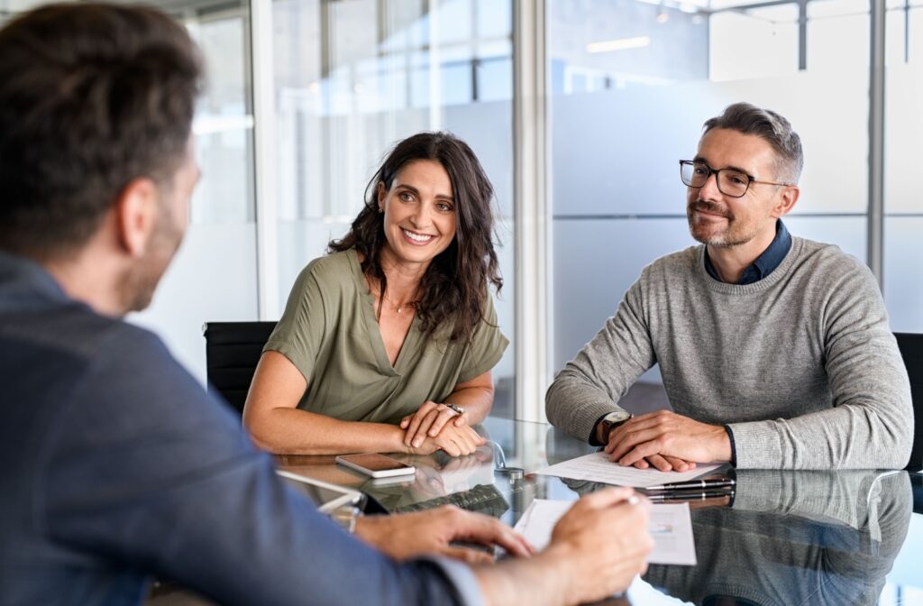 A happy couple meets with their mortgage broker to discuss viable renovation financing options.