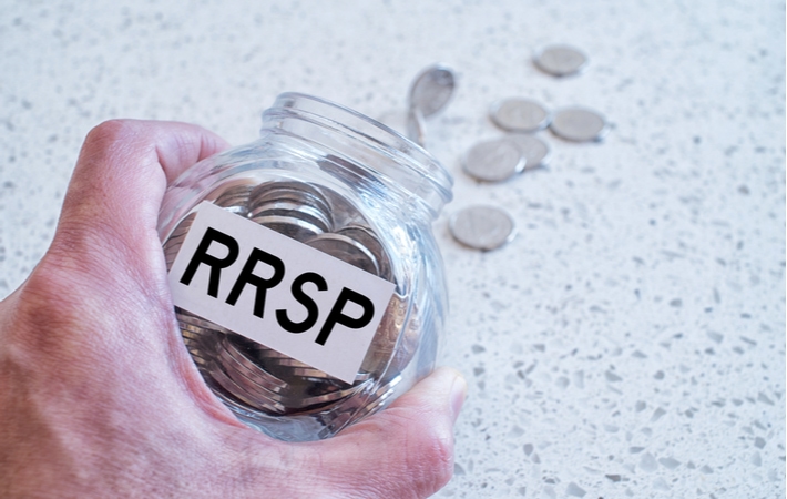 Emptying out a glass jar of coins labelled RRSP