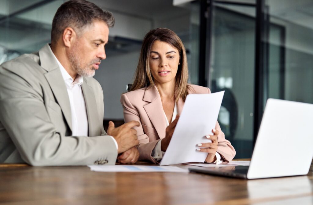 A mortgage broker examining a company owner's financial standing to determine an ideal mortgage option.