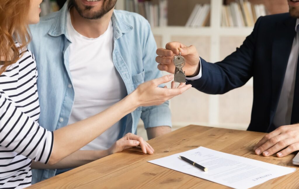 After securing a mortgage for a property in Canada, a young couple is handed the keys to their new home.