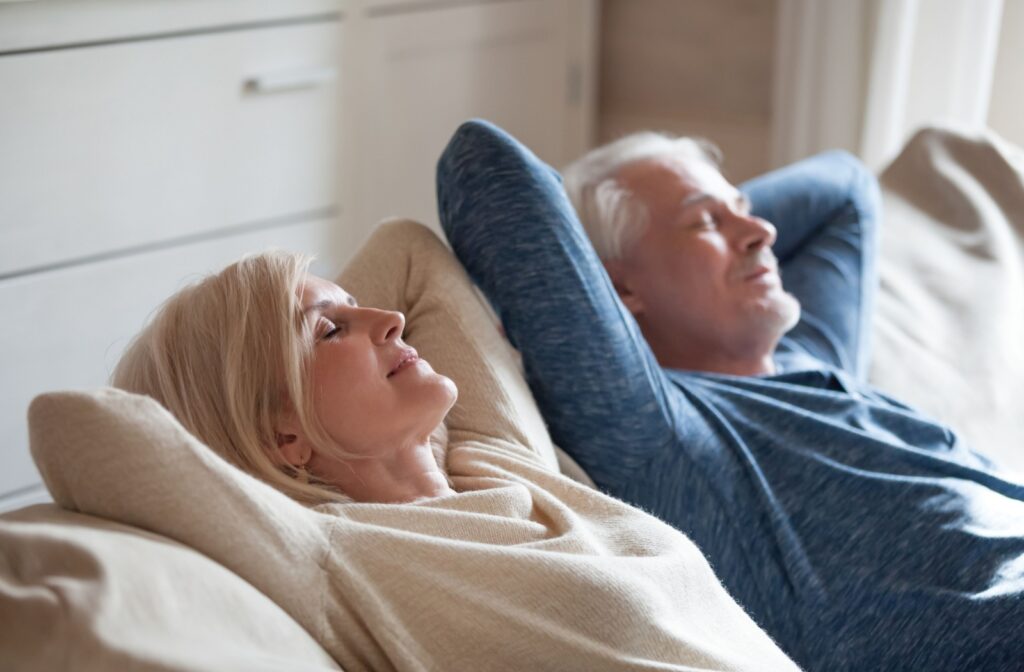 A couple is relaxing in their home after paying off their mortgage.