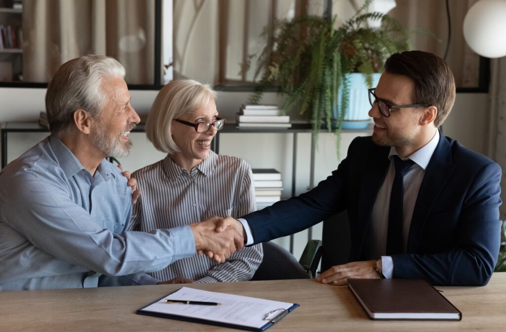 A mature couple discusses borrowing options with a mortgage broker.
