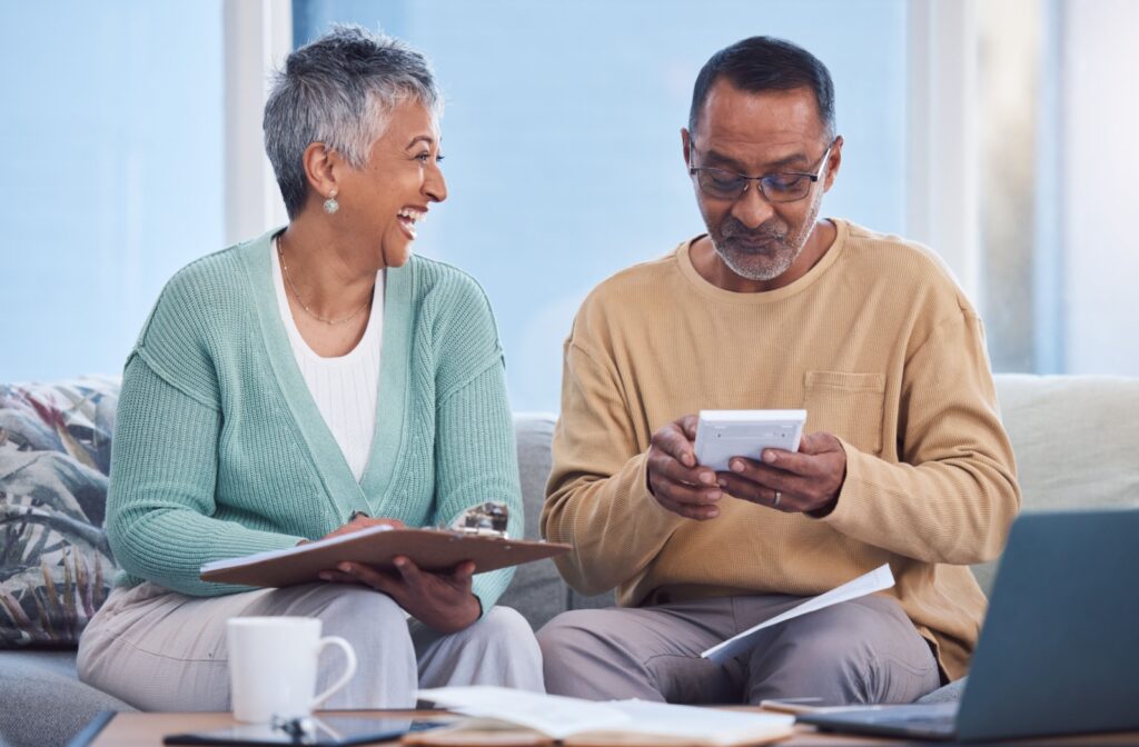 A couple sitting on a couch going through their mortgage renewal checklist.