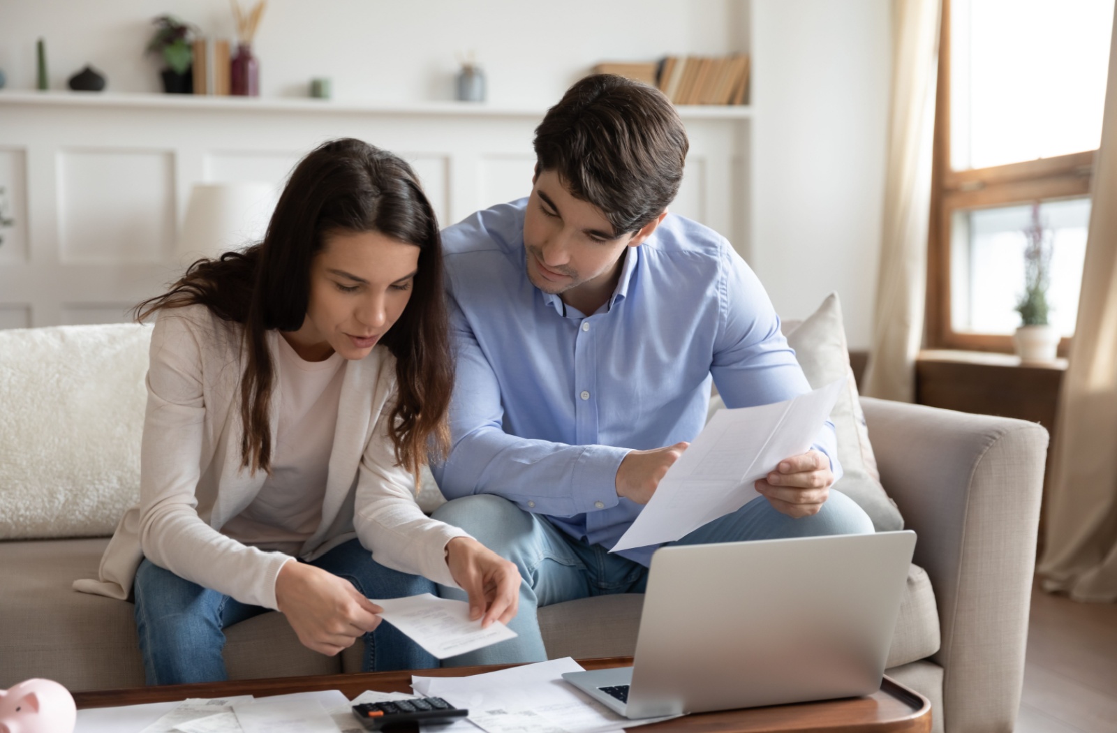 A couple going over their finances and mortgage payments, evaluated a accelerated bi-weekly vs bi-weekly mortgage payment option.